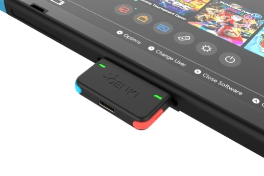 Small USB-C Bluetooth audio transmitter dongle plugged into a Nintendo Switch